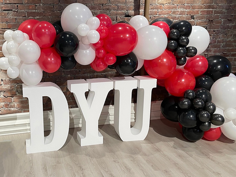 DYU Block letters surrounded by balloons