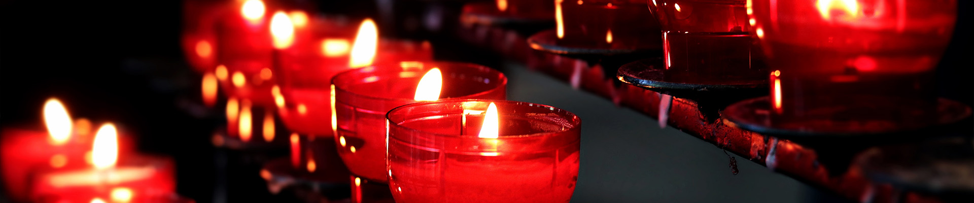 Row of candles in red glass